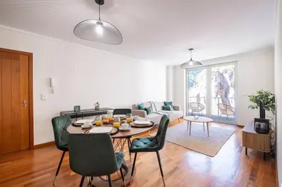 a living room with a table and chairs at Wings Apartment CE by GALMI in Santa Cruz