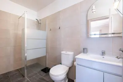 a bathroom with a toilet and a sink and a mirror at Bernarda's House by GALMI in Ponta do Sol