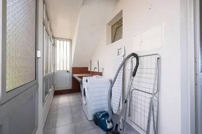 a laundry room with a sink and a washing machine at Bernarda's House by GALMI in Ponta do Sol