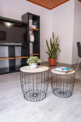 a living room with two tables and a flat screen tv at Alegria's Apartment by GALMI in Calheta