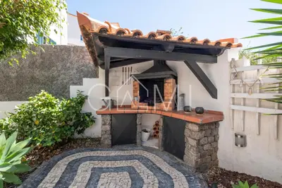 a pizza oven in the side of a building at Stylish Garden Apartment by GALMI in Caniço