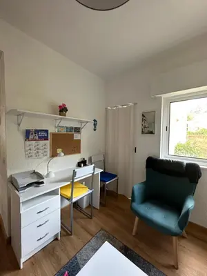 an office with a desk and a chair and a window at Sun Beach Apartment in Machico