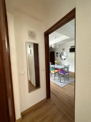 a hallway with a mirror and a dining room at Sun Beach Apartment in Machico