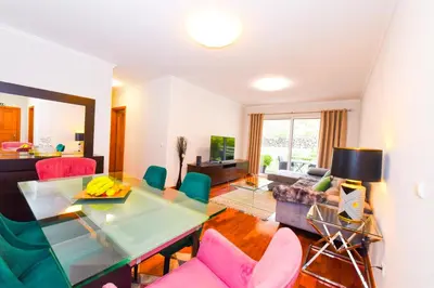 a living room with a table and chairs at Tranquility Apartment in Caniço