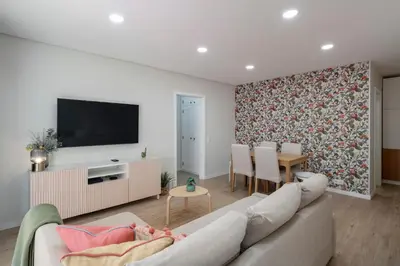 a living room with a couch and a tv at Casa Branca VI by An Island Apart in Funchal