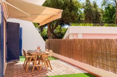 a patio with a table and an umbrella at Casa Branca VI by An Island Apart in Funchal
