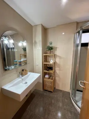a bathroom with a sink and a mirror at Funchal Balcony in Funchal