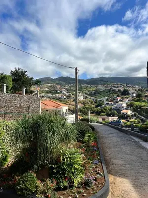 a hammock on a balcony with a table and chairs at Seaside & Mountain Views & Cozy Calheta Retreat MQ1 in Calheta