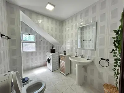 a white bathroom with a sink and a toilet at Seaside & Mountain Views & Cozy Calheta Retreat MQ1 in Calheta