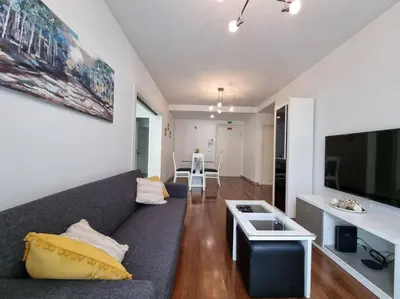 a living room with a couch and a kitchen at Funchal Centrum - La Vie Apartment with Parking! in Funchal