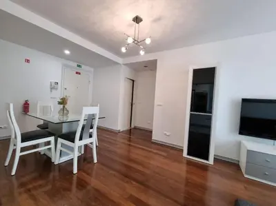 a dining room with a table and chairs and a television at Funchal Centrum - La Vie Apartment with Parking! in Funchal