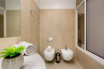 a bathroom with a toilet and a sink at Funchal Centrum - La Vie Apartment with Parking! in Funchal