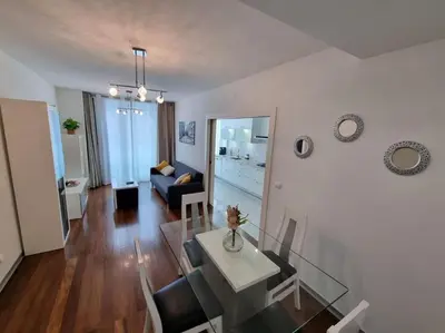 a living room with a table and a dining room at Funchal Centrum - La Vie Apartment with Parking! in Funchal