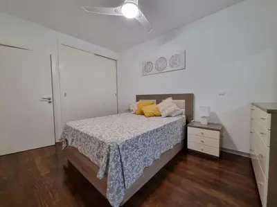a bedroom with a bed and a ceiling fan at Funchal Centrum - La Vie Apartment with Parking! in Funchal