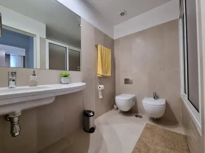 a bathroom with a sink and a toilet at Funchal Centrum - La Vie Apartment with Parking! in Funchal