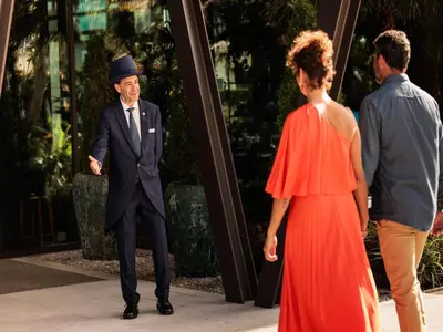 a man in a suit and a woman in a red dress at The Reserve - within Savoy Palace - The Leading Hotels of the World in Funchal