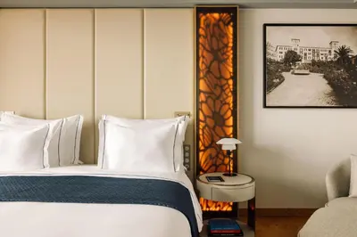 a hotel room with a bed and a chair at The Reserve - within Savoy Palace - The Leading Hotels of the World in Funchal