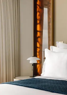 a bedroom with a bed with a lamp next to it at The Reserve - within Savoy Palace - The Leading Hotels of the World in Funchal