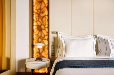 a bedroom with a bed and a side table with a lamp at The Reserve - within Savoy Palace - The Leading Hotels of the World in Funchal
