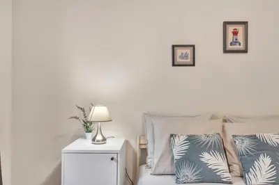 a bedroom with a bed with two pillows and a lamp at Chalé do Areeiro in Funchal