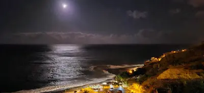 a view of the ocean at night with a full moon at Chalé do Areeiro in Funchal