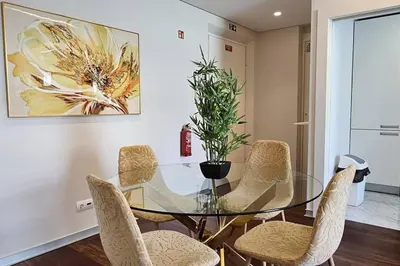 a dining room with a glass table and chairs at Ponte de Estrelas Plaza by Rentallido in Funchal
