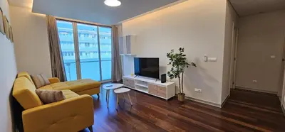 a living room with a couch and a television at Ponte de Estrelas Plaza by Rentallido in Funchal