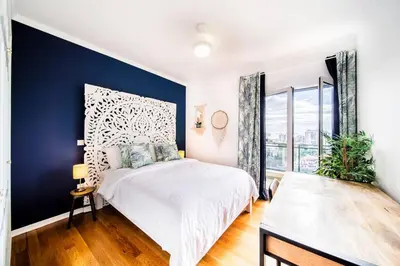 a bedroom with a white bed and a blue wall at Island Feeling in Funchal