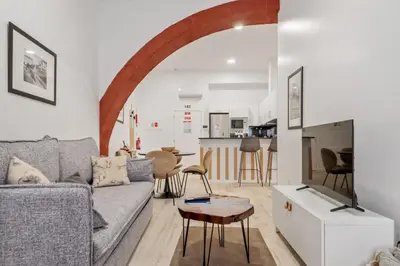 a living room with a couch and a table at Tanoeiros Residence by An Island Apart in Funchal