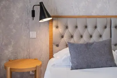 a bedroom with a bed with a pillow and a lamp at Tanoeiros Residence by An Island Apart in Funchal