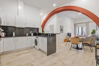 an open kitchen and living room with a table and chairs at Tanoeiros Residence by An Island Apart in Funchal