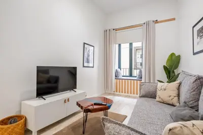 a living room with a couch and a tv at Tanoeiros Residence by An Island Apart in Funchal