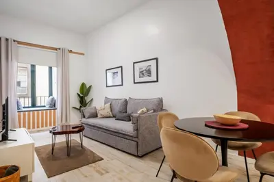 a living room with a couch and a table at Tanoeiros Residence by An Island Apart in Funchal