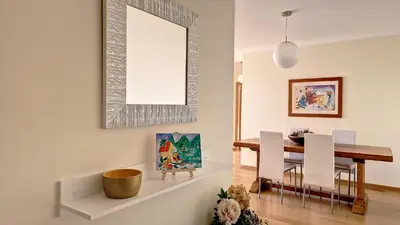 a dining room with a table and a mirror at Lucy Sweet Home by LovelyStay in Caniço