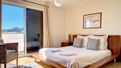 a bedroom with a bed and a large window at Lucy Sweet Home by LovelyStay in Caniço
