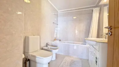 a bathroom with a toilet and a sink and a tub at Lucy Sweet Home by LovelyStay in Caniço