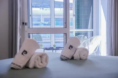 a pair of slippers sitting on a table in a room at Barreiros ArchDesign Apartment in Funchal