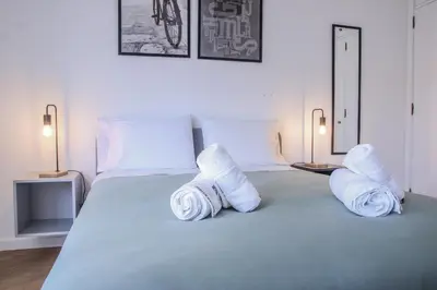 a bedroom with a bed with rolled towels on it at Barreiros ArchDesign Apartment in Funchal