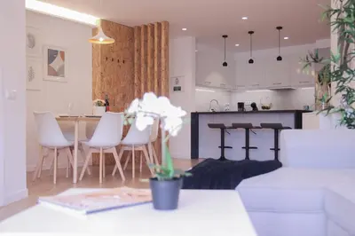 a kitchen and living room with a table and chairs at Barreiros ArchDesign Apartment in Funchal