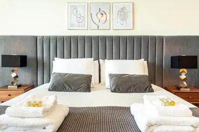 a bedroom with a large bed with two pillows at Moradia Vista Atlântico in Funchal