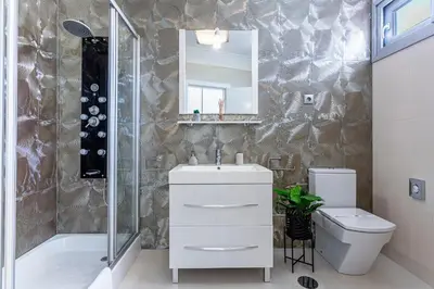 a bathroom with a sink and a toilet and a shower at Moradia Vista Atlântico in Funchal
