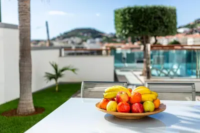 a bowl of fruit on top of a table at Moradia Vista Atlântico in Funchal