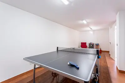 a ping pong table in the middle of a room at Moradia Vista Atlântico in Funchal