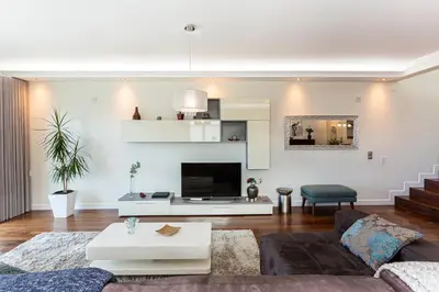 a living room with a couch and a tv at Moradia Vista Atlântico in Funchal
