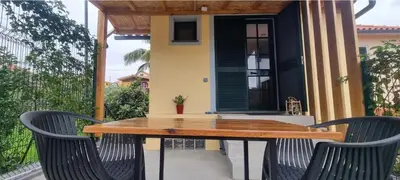 a wooden table and two chairs on a patio at Studio em Machico in Machico