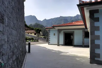 a building with a doorway with mountains in the background at Casa Da Achada, By OP in São Vicente