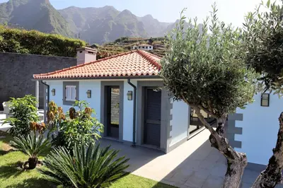 a white house with mountains in the background at Casa Da Achada, By OP in São Vicente