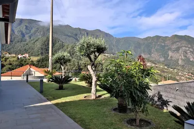 a garden with trees and mountains in the background at Casa Da Achada, By OP in São Vicente