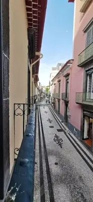 an empty street in a city with buildings at Franciscus 1a in Funchal
