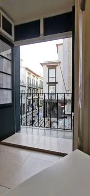 an open door to a balcony with a view of a building at Franciscus 1a in Funchal